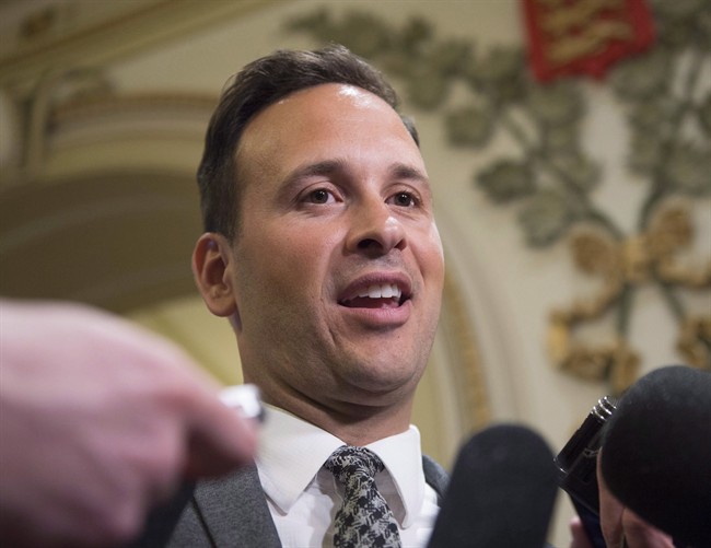 Parti Québécois MNA Alexandre Cloutier responds to reporters' questions before entering a party caucus meeting, Tuesday, May 10, 2016 at the legislature in Quebec City. Cloutier has entered the race to succeed Pierre Karl Péladeau as leader of the PQ.