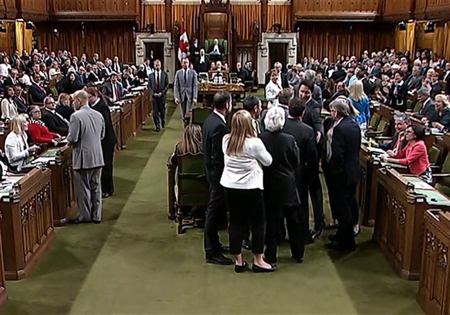 Canadian Prime Minister Justin Trudeau, face towards the camera left of centre of the frame, is shown near Opposition whip Gordon Brown in the House of Commons in Ottawa on Wednesday May 18, 2016. Footage from the Commons television feed shows Trudeau wading into a clutch of MPs, mostly New Democrats, and pulling Opposition whip Gordon Brown through the crowd in order to get a vote started. THE CANADIAN PRESS/HO-House of Commons .
