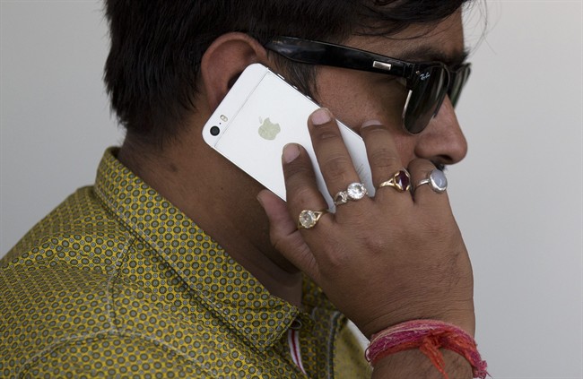An Indian man talks on his iPhone in New Delhi, India.