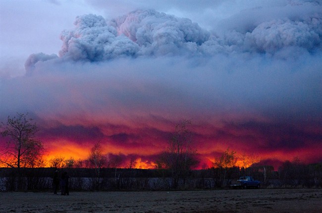 Clouds of ash rise into the atmosphere as fires rage across Fort McMurray.