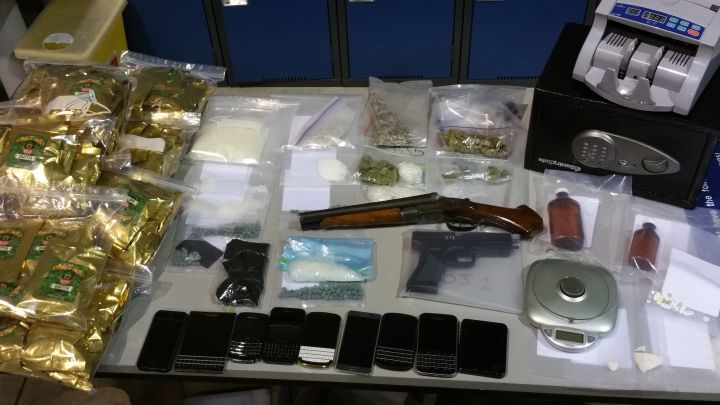 Edmonton police show off drugs and weapons seized in the city's north end after search warrants were conducted on May 20, 2016.