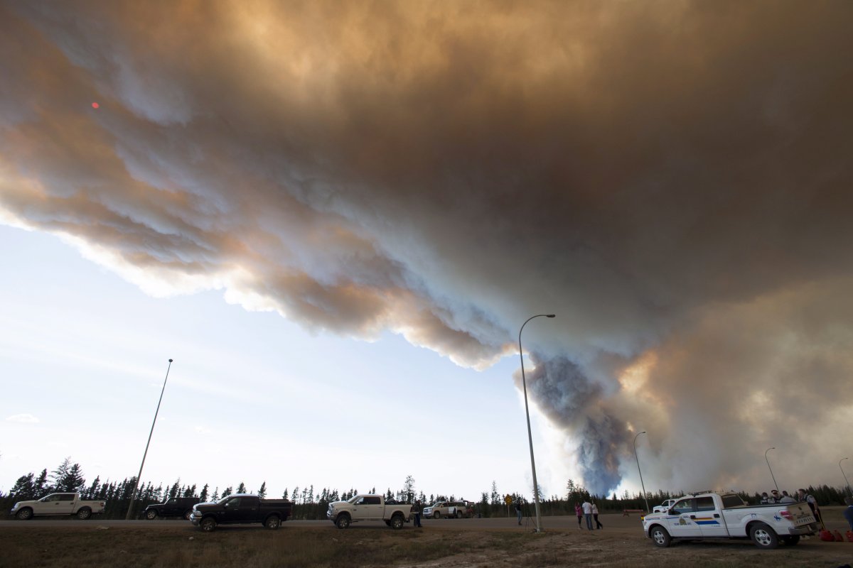 Smoke rises from a wildfire 30km south of Fort McMurray, Alberta on highway 63 Friday, May 6, 2016.