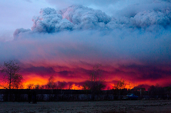 A wildfire moves towards the town of Anzac from Fort McMurray, Alta., on Wednesday May 4, 2016.