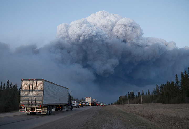 Drivers wait for clearance to take firefighting supplies into town on May 05, 2016 outside of Fort McMurray, Alberta.