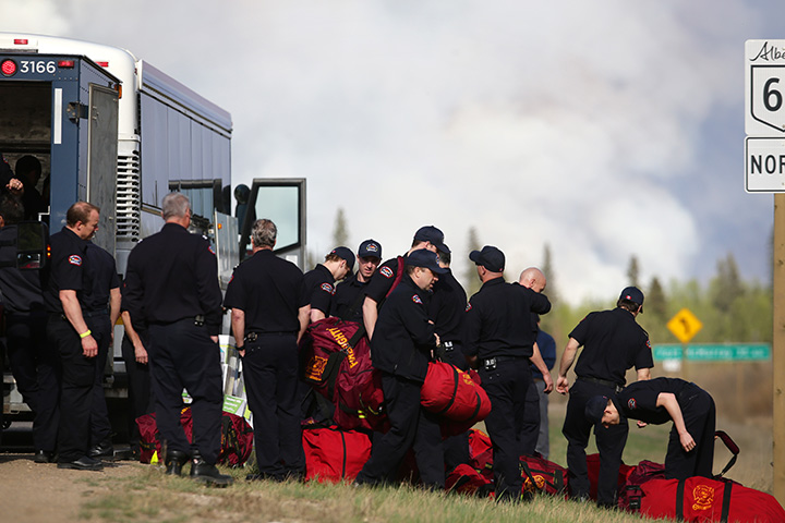 Firefighters assemble on Highway 63 near Fort McMurray, Alberta on May 5, 2016.