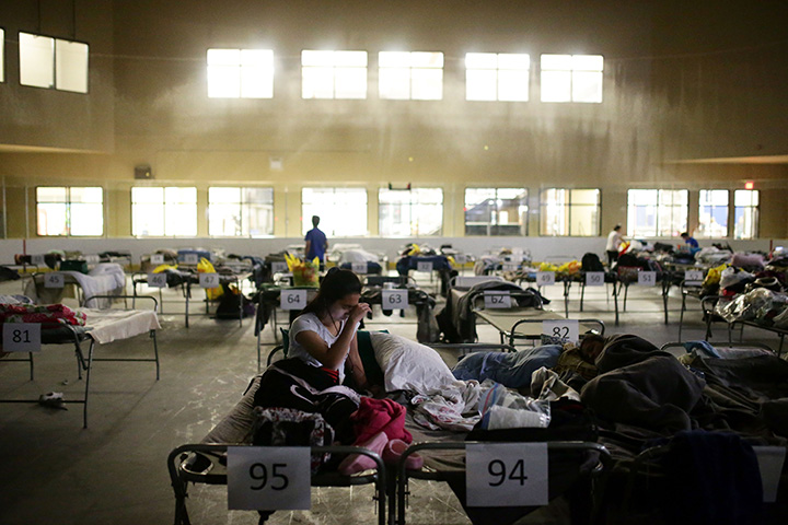 Tyra Abo sits on a cot at a makeshift evacuee centre in Lac La Biche, Alberta on May 5, 2016, after fleeing forest fires north of Fort McMurray.