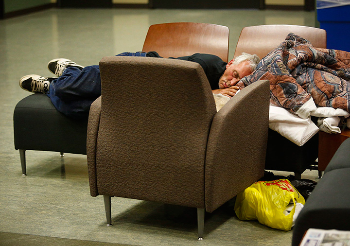 An evacuee from the Fort McMurray wildfire sleeps on chairs at the evacuation centre in Lac La Biche, Alta., Thursday, May 5, 2016.