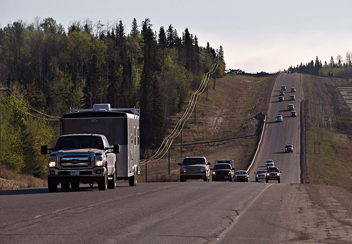 Evacuees leave Fort McMurray in the early morning after being stranded north of wildfires which have been raging in the northern Alberta city on Friday, May 6, 2016.