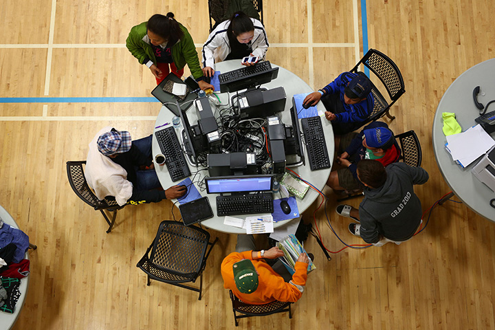People use the Internet at a makeshift evacuee centre in Lac La Biche, Alberta, Canada, on May 5, 2016 after fleeing forest fires in Fort McMurray.