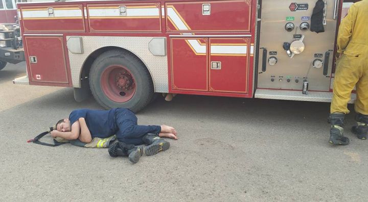 A firefighter takes a rest from battling a wildfire in Fort McMurray. Uploaded to Facebook by a firefighter and EMT with the Regional Municipality of Wood Buffalo on May 6, 2016. Date and exact location of photo is unknown. (CREDIT: Facebook/ Troy Palmer)