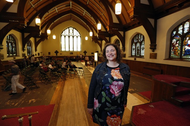 Leanne Moussa, co-owner along with other local residents of the All Saints Anglican Church, stands in the main part of the church during a book launch reception in Ottawa, Thursday May 26, 2016. The idea of turning her local Ottawa church into a community hub was at the forefront of Moussa's mind when the building went up for sale two years ago. THE CANADIAN PRESS/Fred Chartrand.