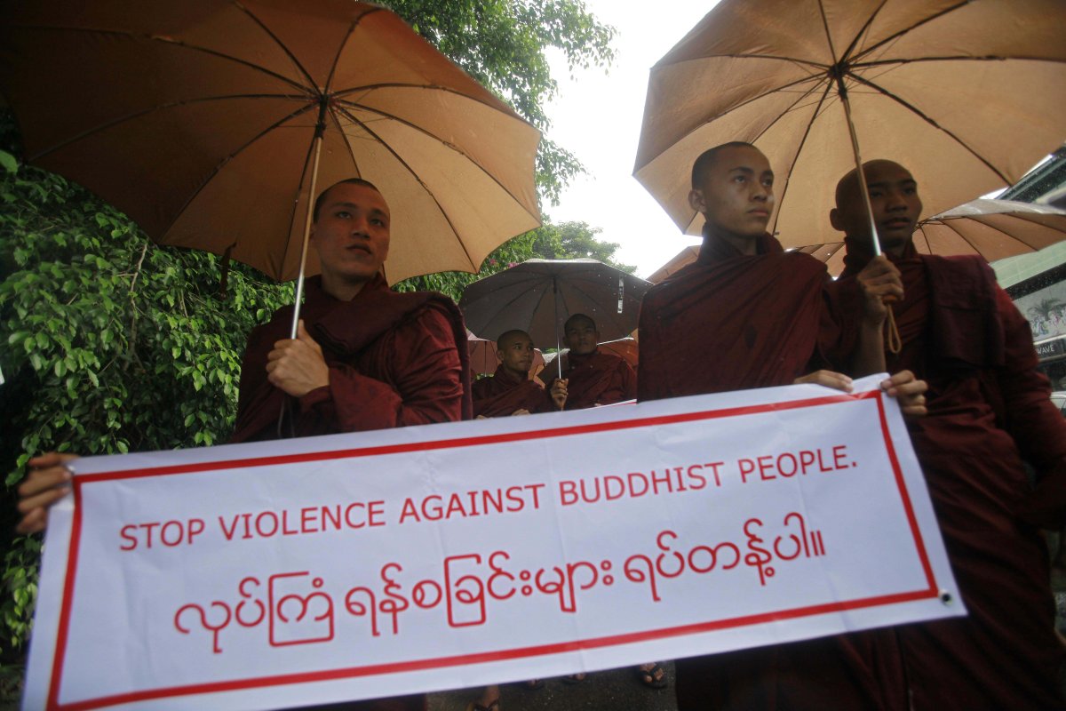 Myanmar Buddhist monks hold signs as they stage a demonstration near the Bangladesh embassy denouncing  mob attacks on Buddhist temples in neighbouring Bangladesh, in Yangon on October 8, 2012. 