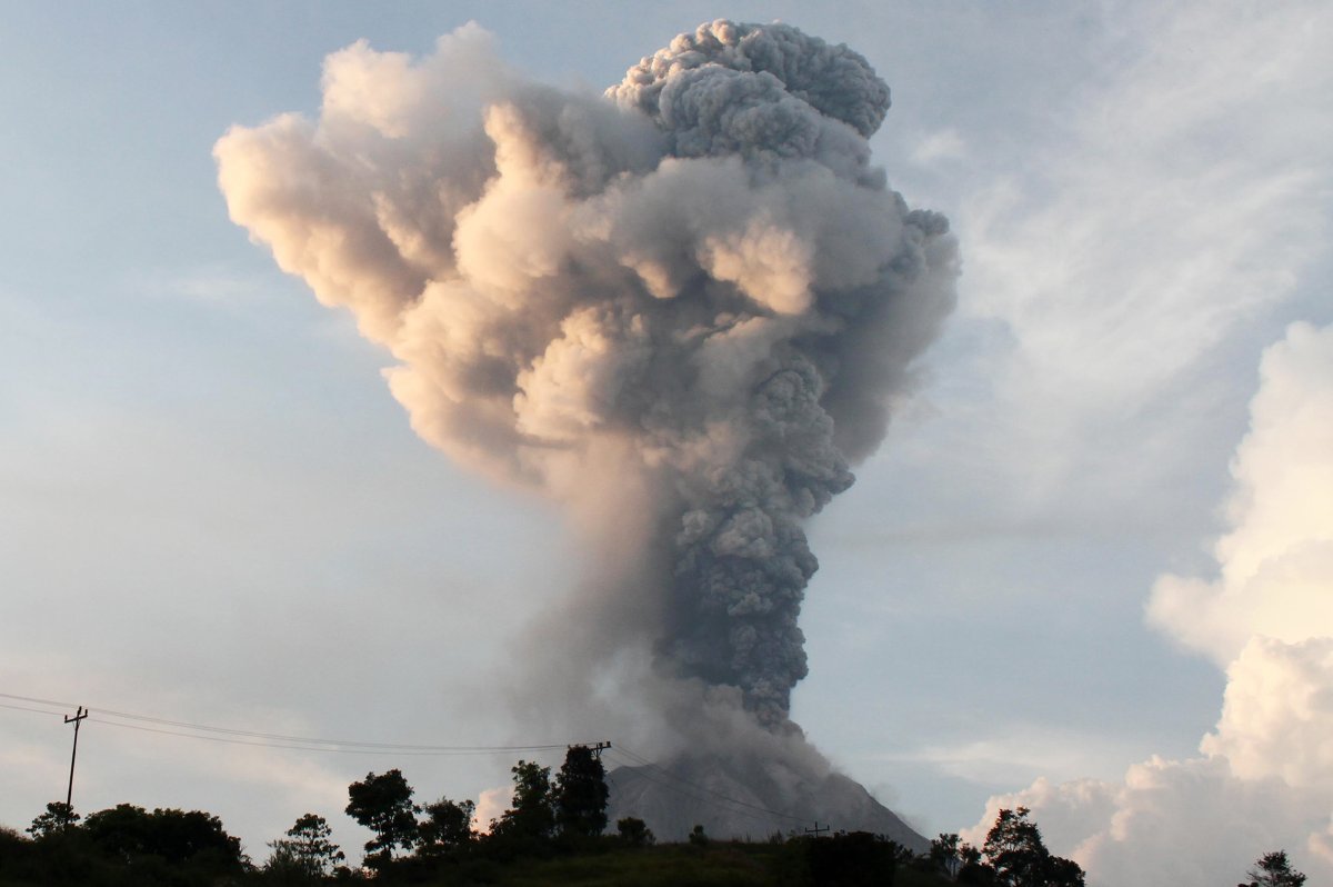 In this picture taken on February 27, 2016 from Sibintun village, Karo district in Indonesia's North Sumatra, volcanic ash spews from Mount Sinabung. Sinabung is one of 129 active volcanoes in Indonesia, which sits on the Pacific Ring of Fire, a belt of seismic activity running around the basin of the Pacific Ocean.