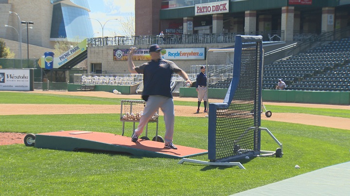 Manager Rick Forney makes a throw at Winnipeg Goldeyes batting practice.