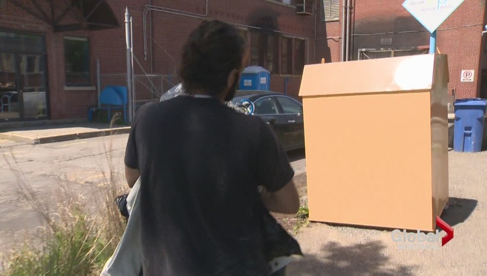 A man walks past a charity bin in Montreal.