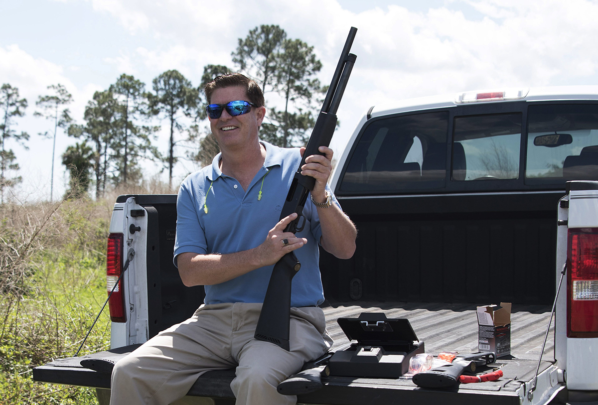 In this photo taken April 7, 2016, Jonathan Mossberg, whose iGun Technology Corp. is working to develop a "smart gun," poses with the firearm, in Daytona Beach, Fla. 