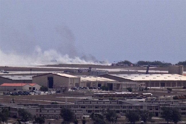 Smoke from the crash of a B-52 is seen on the flight line at Andersen Air Force Base from Mt. Santa Rosa, Yigo Guam, Thursday, May 19, 2016. The U.S. Air Force said Thursday a B-52 crashed on Guam shortly after takeoff, but all seven crew members made it out safely. No injuries were reported. (Rick Cruz/The Pacific Daily via AP).