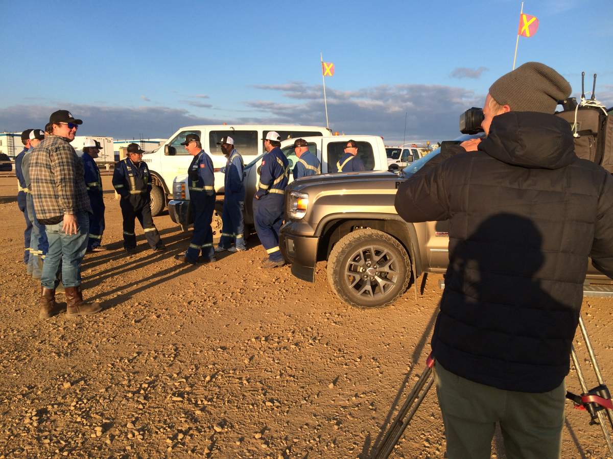 Global News photographer Dani Lantela takes shots of a work crew who helped save Anzac