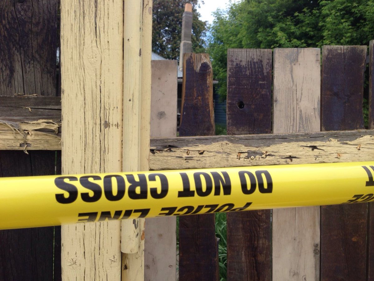Police tape up, blocking access to the backyard of a home in the 1600 block of 33rd Street in Vernon on Sunday.
