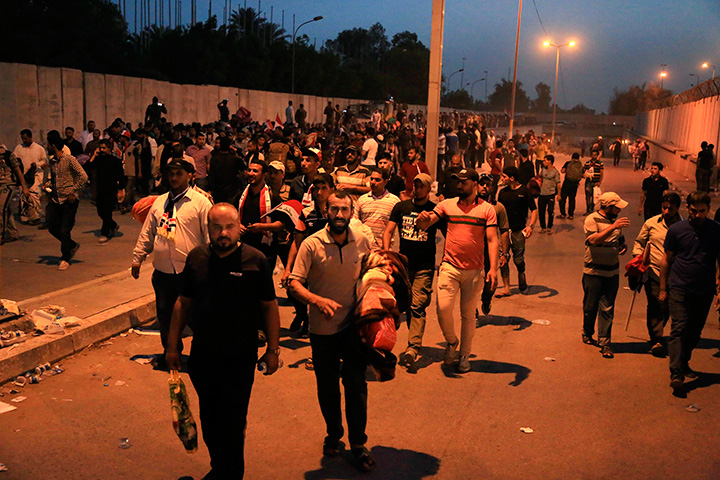 Supporters of Shiite cleric Muqtada al-Sadr leave Baghdad's highly fortified Green Zone Sunday, May 1, 2016. 