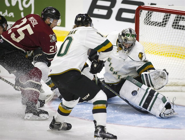 London Knights goalie Tyler Parsons, right, stops a shot from Red Deer Rebels' Adam Musil, during first period CHL Memorial Cup hockey action in Red Deer, Friday, May 20, 2016.