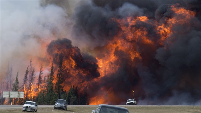 A giant fireball is seen as a wildfire rips through the forest along Highway 63, 16kilometres south of Fort McMurray, Alta., Saturday, May 7, 2016. 