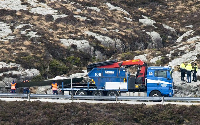 Helicopter rotor blades are loaded onto a truck following the Friday April 29 helicopter crash on the coast of Norway near Bergen, Sunday May 1, 2016. Investigators say the fatal crash was due to mechanical failure.