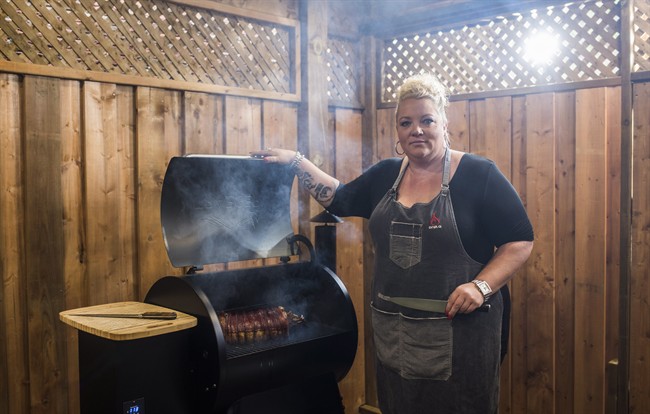 Danielle Bennett poses while cooking her "Filipino Style-Stuffed Pork Belly", a recipe in her cookbook "Diva Q's Barbecue," at the Dickson Barbecue Centre in Toronto, Wednesday May 18, 2016.