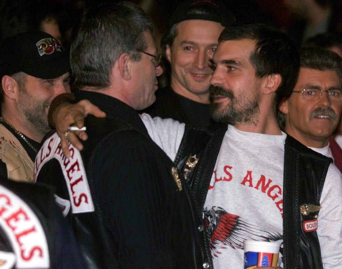 Hells Angels boss Maurice "Mom" Boucher (2nd left), is greeted by other club members at a boxing match in Montreal.
