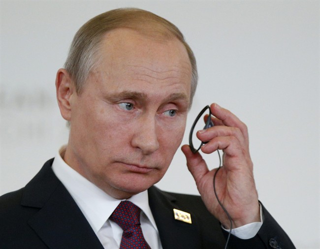 Russian President Vladimir Putin attends a joint news conference.