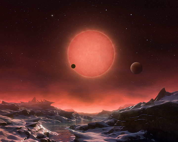 The artist's impression provided by European Southern Observatory on May 2, 2016 shows an imagined view from the surface one of the three planets orbiting an ultra-cool dwarf star just 40 light-years from earth that were discovered using the TRAPPIST telescope at ESO's La Silla Observatory. 
