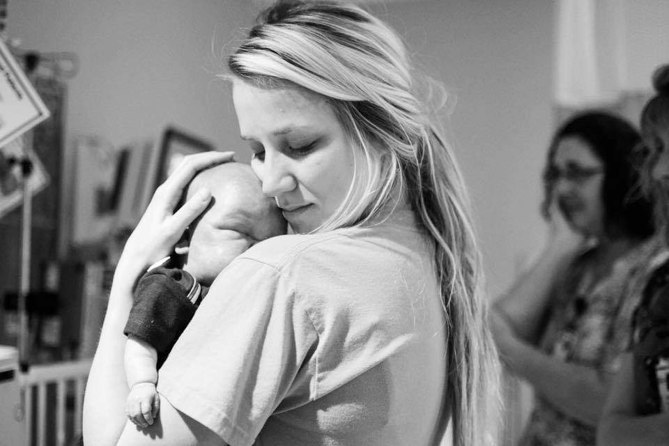 NICU nurse Brittany French with a five-month-old who passed away. "This picture just says everything," said his mom Sarah Colgrove. 