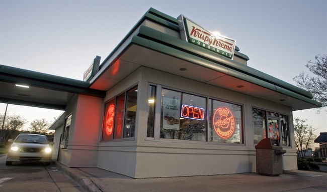 In this April 17, 2008, file photo, a customer picks up doughnuts at the drive through at a Krispy Kreme store in Matthews, N.C.