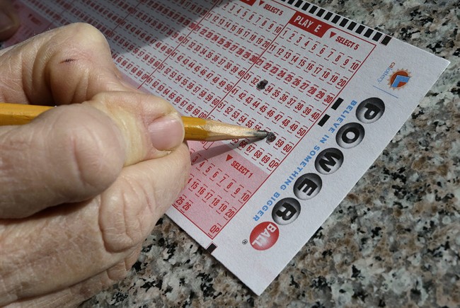  In this Jan. 12, 2016 file photo, a lottery player fills out numbers on a powerball form in Oakland, Calif.
