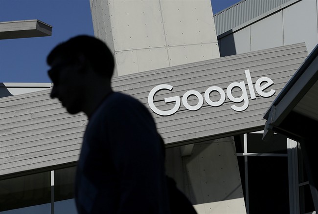  In this Nov. 12, 2015, file photo, a man walks past a building on the Google campus in Mountain View, Calif. 