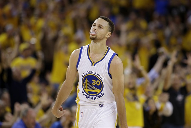 Golden State Warriors guard Stephen Curry (30) reacts after scoring against the Oklahoma City Thunder during the first half of Game 1 of the NBA basketball Western Conference finals in Oakland, Calif., Monday, May 16, 2016. 
