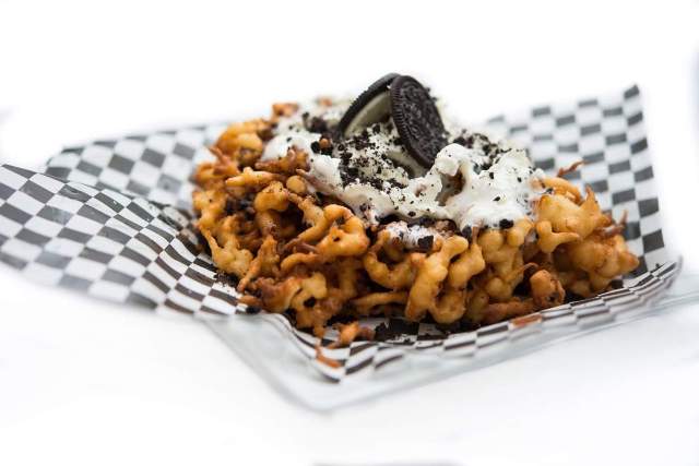 Oreo cookies are crushed and combined with traditional funnel cake batter and topped with Oreo cream Icing, Oreo cookies and fresh whipped cream.