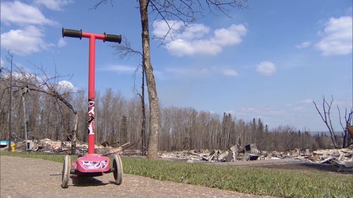 A pink scooter sits untouched in Fort McMurray Friday, May 13, 2016 after a wildfire tore through the community, .