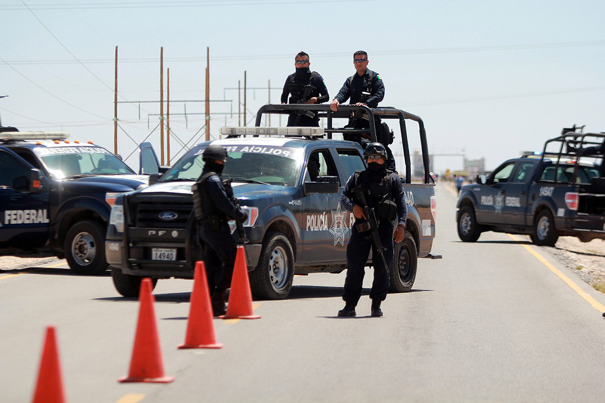 Mexican federal police guard a road leading to the Cefereso No. 9 federal prison in Ciudad Juarez, Mexico, Saturday, May 7, 2016. 