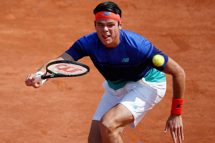 Canada's Milos Raonic runs to return the ball to Slovakia's Andrej Martin during their third round match of the French Open tennis tournament at the Roland Garros stadium, Friday, May 27, 2016 in Paris. 