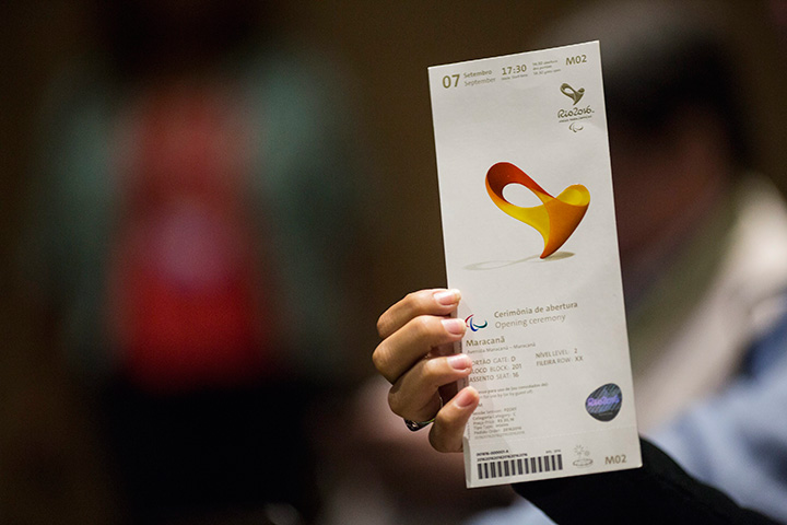 A journalist shows the Olympic ticket she won during a news conference where the design of Olympic Games tickets was unveiled in Rio de Janeiro, Brazil, Friday, May 20, 2016. 