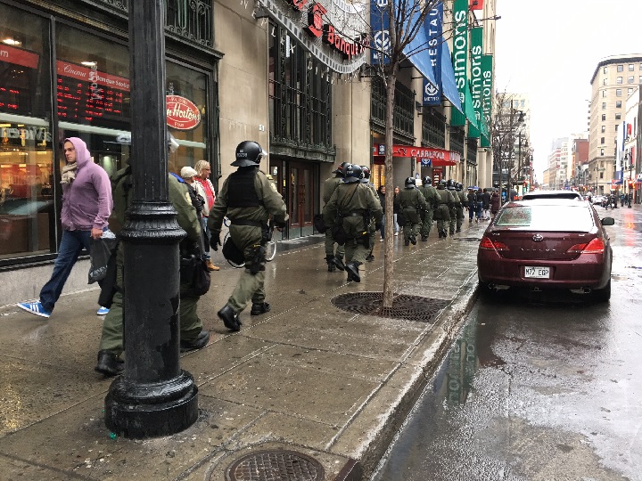 Tensions are high as police in riot gear head down Montreal’s Sainte-Catherine Street during a May Day anti-capitalist protest. Sunday, may 1, 2016.