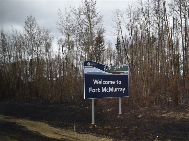 File photo of a sign welcoming visitors to Fort McMurray during a media tour of the fire-damaged Alberta city on Monday, May 9, 2016.