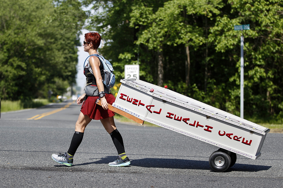 Greta Schwartz, of Seaville, N.J., is dressed like a Spartan warrior pulling a casket as she walks along route 206, from southern New Jersey to Trenton Tuesday, May 31, 2016, in Tabernacle, N.J. 