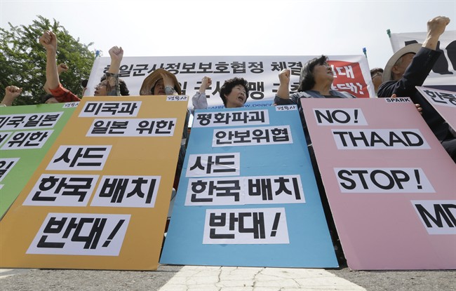 South Korean protesters stage a rally denouncing the United States, South Korean and Japanese governments' missile policies on North Korea in front of the Defense Ministry in Seoul, South Korea, Tuesday, May 31, 2016.