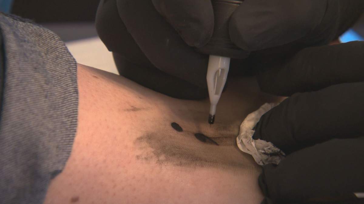 Edmontonians show their support for mental health by getting a semicolon tattoo.