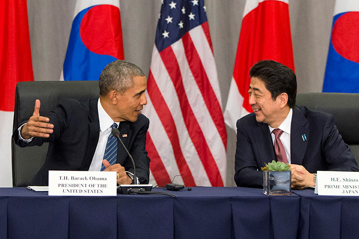 In this March 31, 2016, file photo, U.S. President Barack Obama speaks with Japanese Prime Minister Shinzo Abe during their meeting at the Nuclear Security Summit in Washington. 