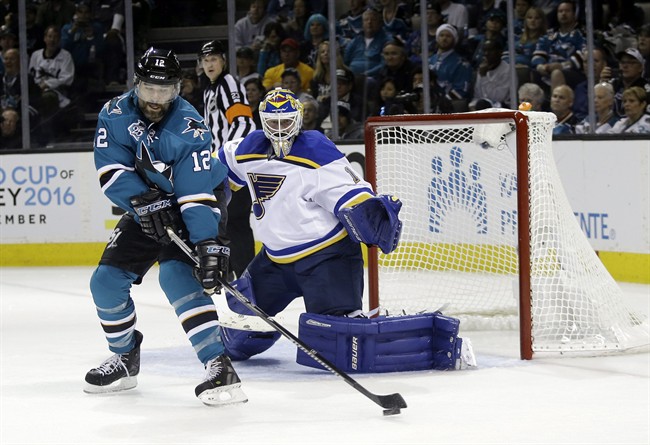 San Jose Sharks' Patrick Marleau (12) reaches for the puck next to St. Louis Blues goalie Brian Elliott (1) during the second period in Game 6 of the NHL hockey Stanley Cup Western Conference finals Wednesday, May 25, 2016, in San Jose, Calif. ).