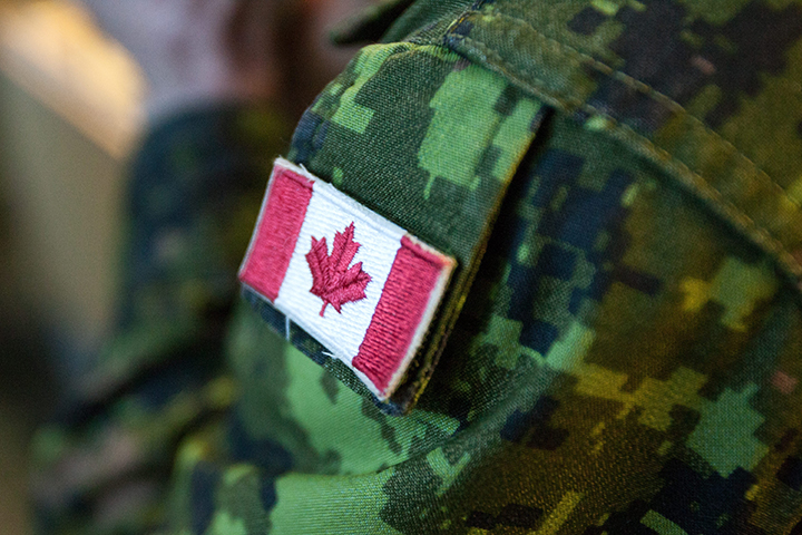 A Canadian flag patch is seen on a soldier's uniform.