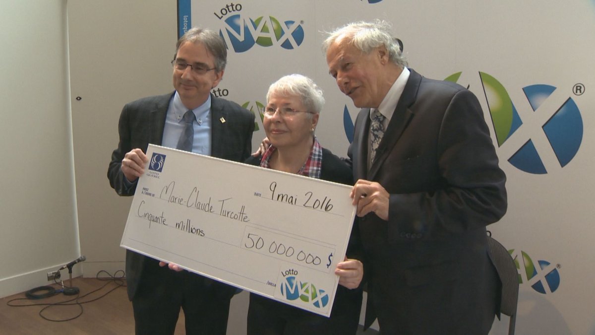 Marie-Claude Turcotte holds up her $50 million Lotto Max jackpot cheque, Monday, May 9, 2016.